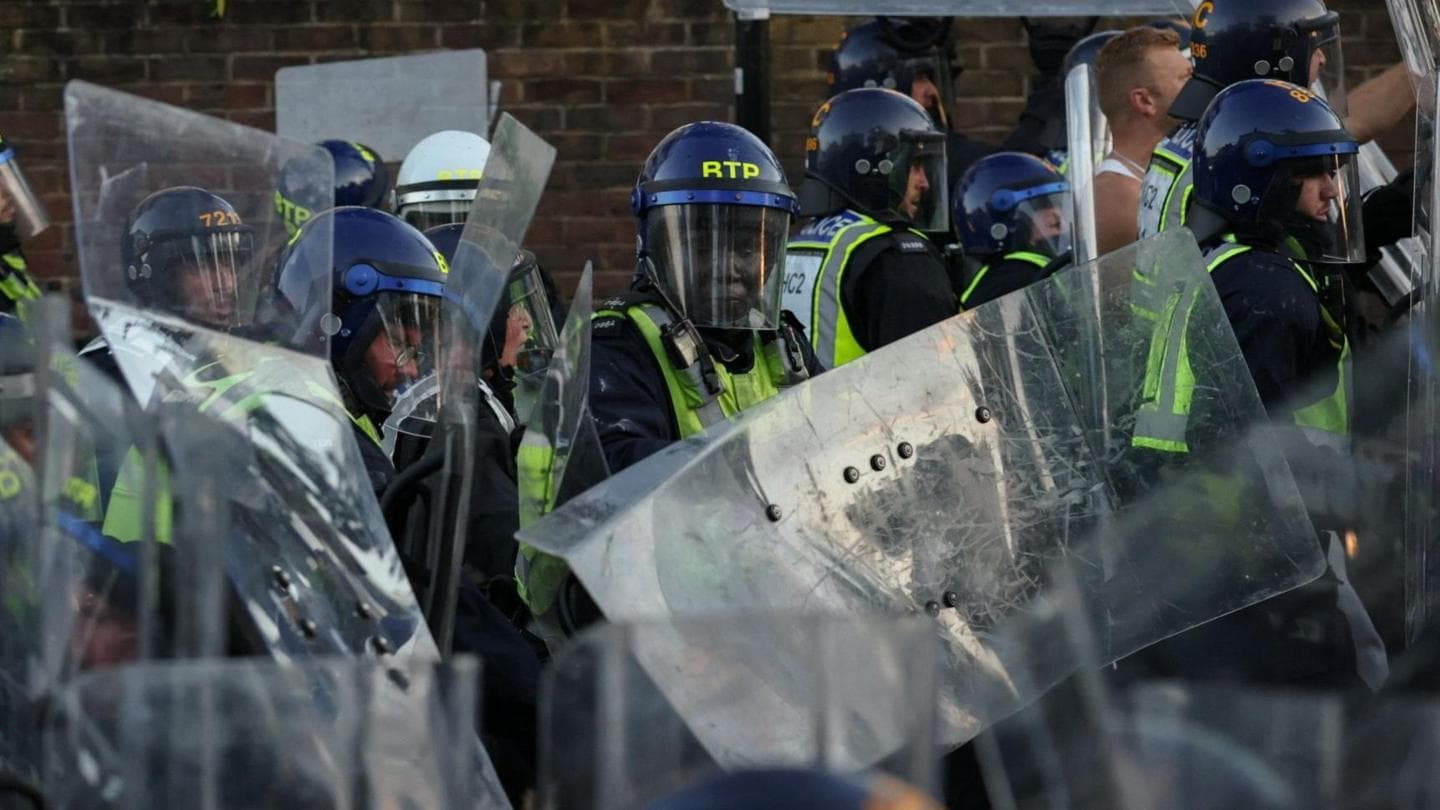 Protesters and riot police confront each other near the residence of Nowak's murderer