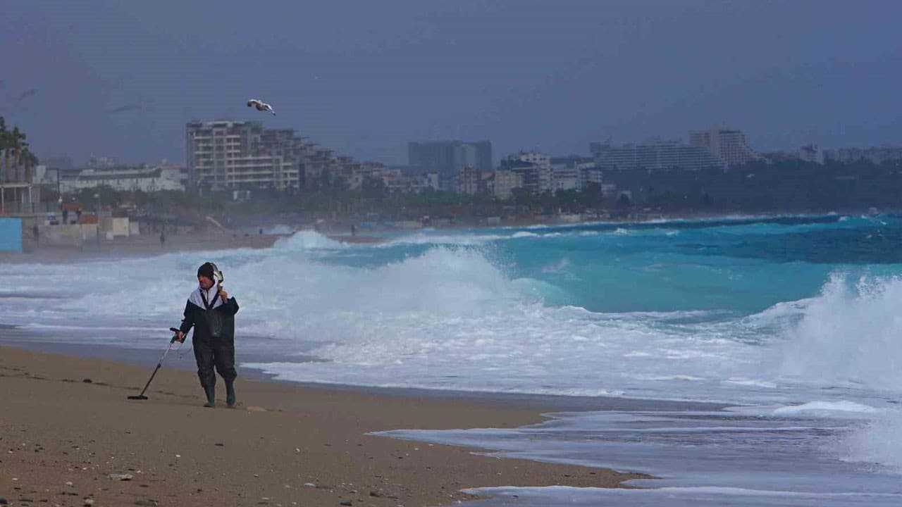 Antalya'da define avcıları fırtınada iş başında: Dev dalgaların vurduğu sahilde dedektörle arama yaptılar