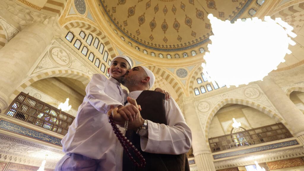 In pictures: Muslims celebrate Eid al-Fitr across the world in shadow of Middle East war