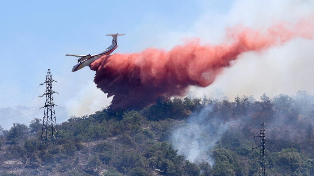 Firefighters Utilize Red Fire Retardant in Southern France Wildfires